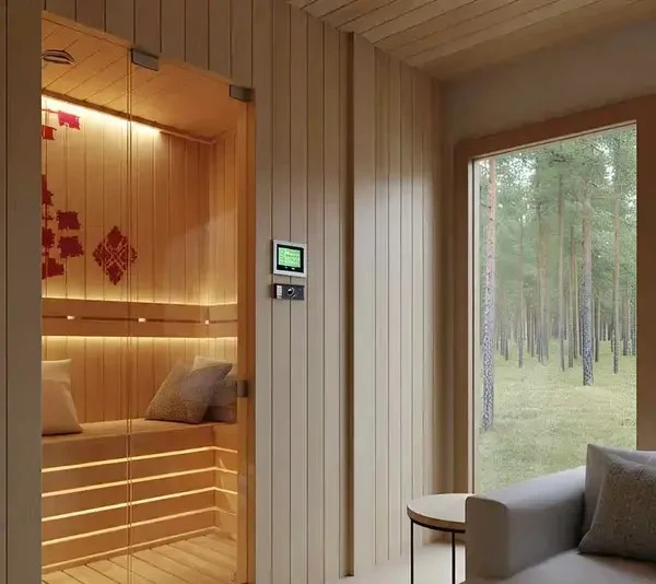  A sauna room featuring a couch and a window, creating a warm and inviting atmosphere for relaxation.