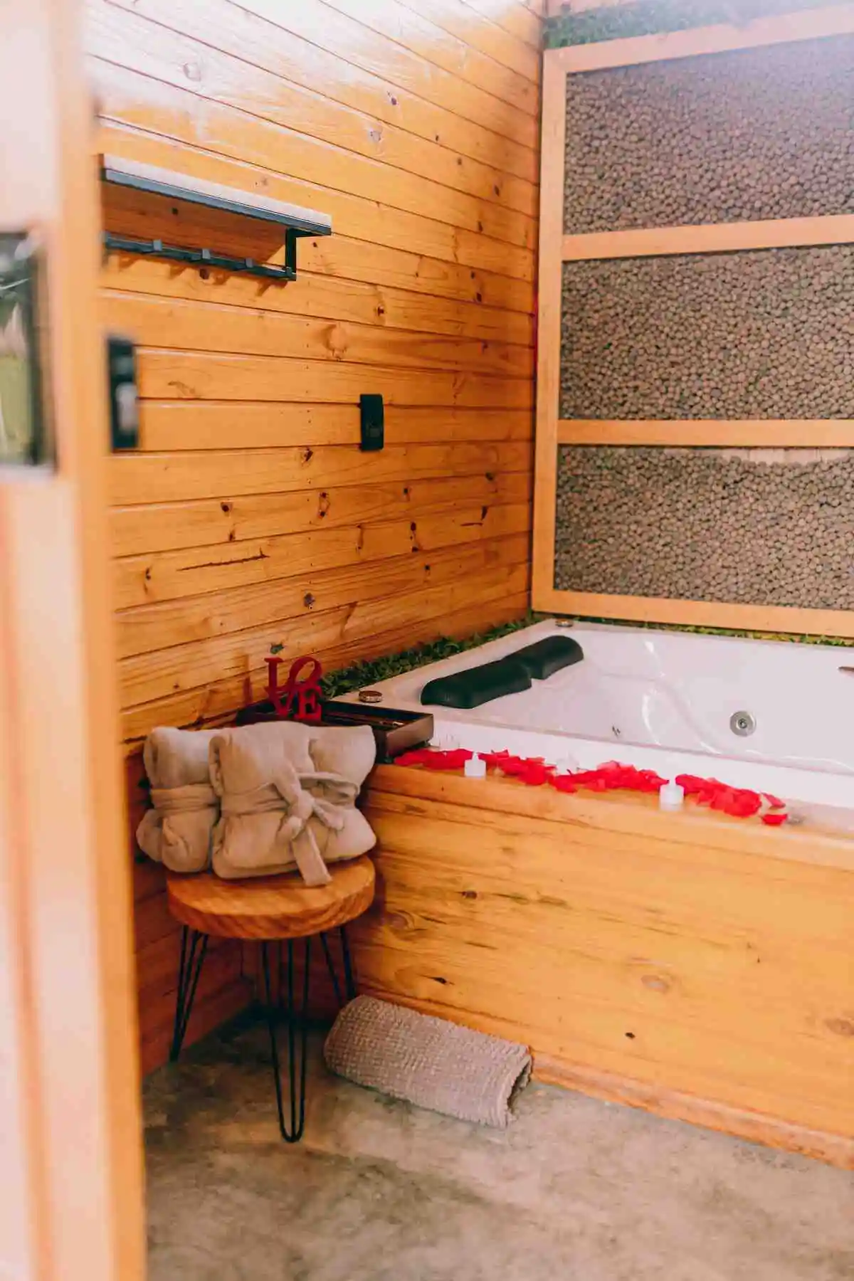 A bright, plant-filled bathroom with natural light and eco-friendly fixtures - the perfect relaxing space (wondering 'can I bring my phone in a sauna?' - this serene environment might make you want to unplug).