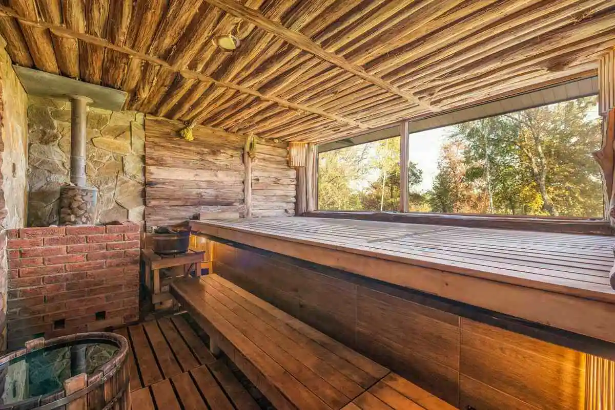A wooden sauna with benches and rocks—discover where to buy sauna rocks for an authentic steam experience.